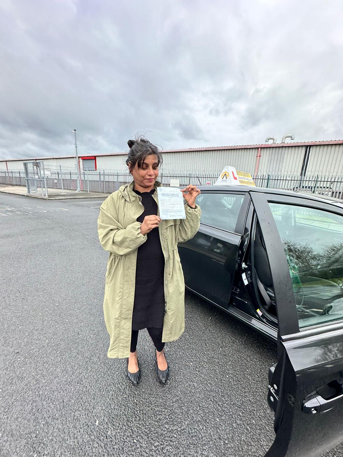 Learner celebrating a driving test pass with Sara