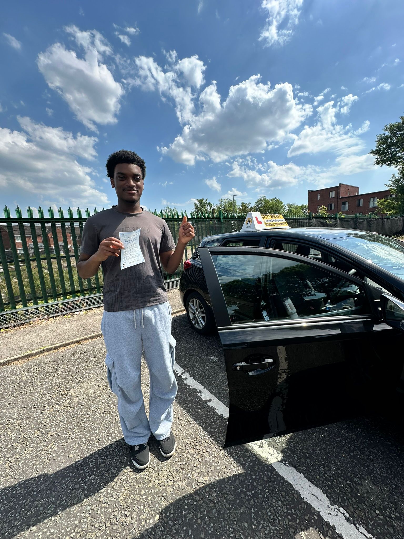 Learner celebrating a driving test pass with Sara