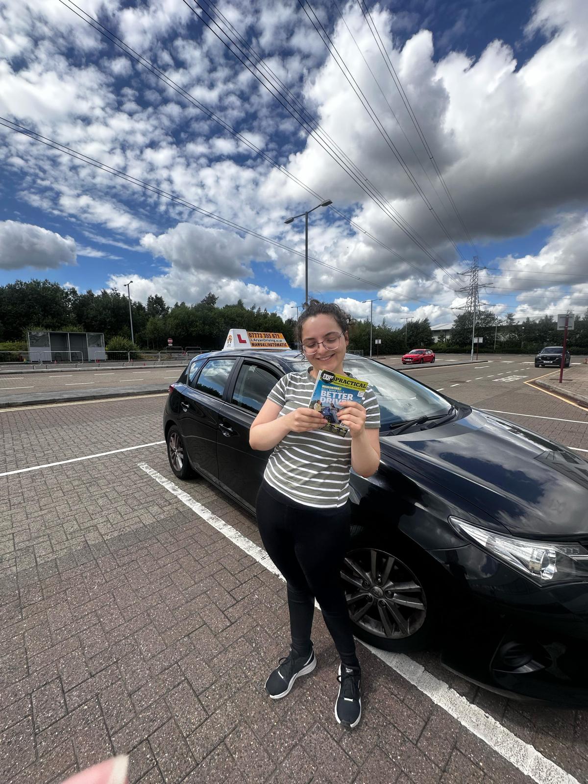 Learner celebrating a driving test pass with Sara