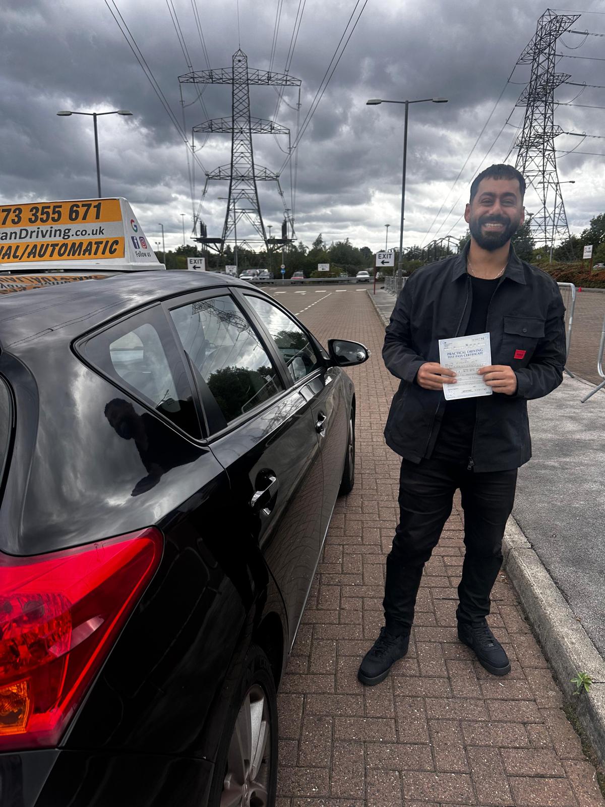 Learner holding a driving test pass certificate
